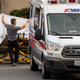 Health care workers transport a coronavirus patient into an ambulance at Life Care Center of Kirkland on February 29, 2020 in Kirkland, Washington.